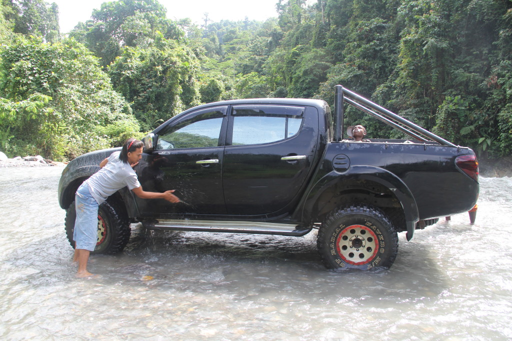 Cleaning the truck in the river